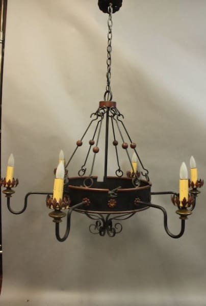 An 16092. Original Spanish Revival 1920's Chandelier Made in Los Angeles with candle-style lights and decorative wooden beads hanging from a chain against a grey backdrop.