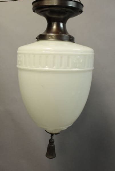 Vintage 1920's ceiling mount with glass pendant and tassel, featuring a classic pull-chain.