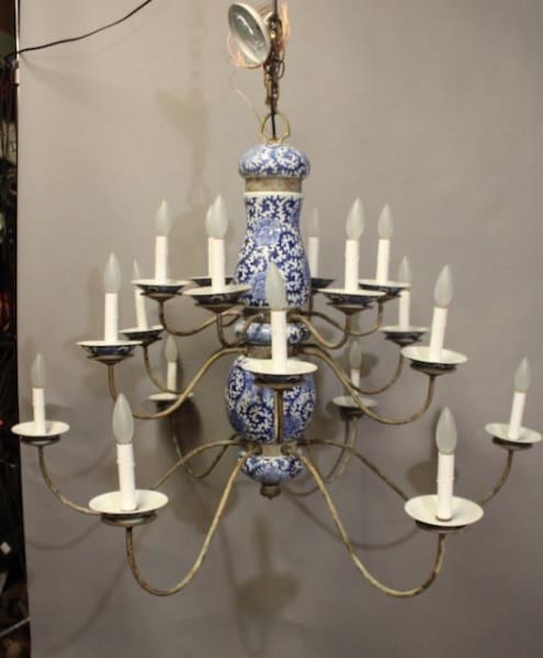 16203 porcelain chandelier with curved metal arms and candle-like bulbs, suspended against a neutral background.