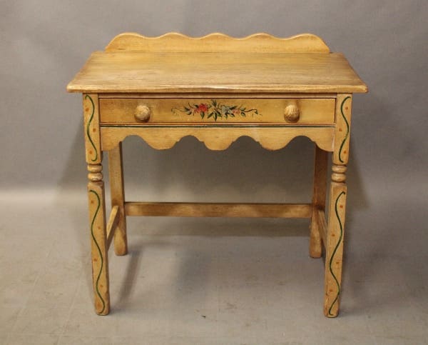 16252. 1920's Monterey Period Small Desk With One Drawer with decorative floral motifs and scalloped top, featuring spindle legs.