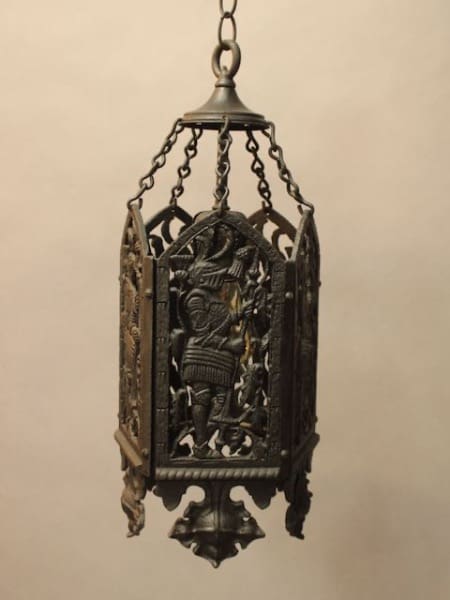 An ornate 16294. 1920's Pendant With Knight Motif hanging lantern with detailed relief carvings of a knight on its panels, suspended from a chain.