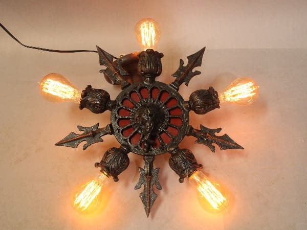 A 16314. Rare 1920's Spanish Revival Polychrome Ceiling Mount with Four Lights with a central lion design, ornate arms, and six glowing bulbs on a white background.