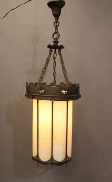 Antique-style hanging chandelier with three 16390. Brass Pendants With Original Glass Circa 1920's enclosed in a metal frame, illuminated and suspended by chains.