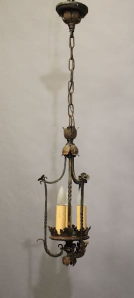 Antique 16413. Spanish Revival 1920's Pendant With Original Finish hanging from a ceiling, features ornate metalwork with floral designs and a chain suspension.