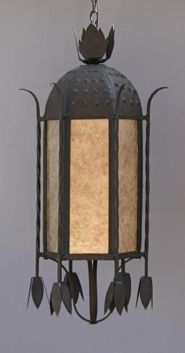 Sentence with the product name inserted: A 1657 Large Exterior Pendant w/Mica with a metal frame and leaf motifs, featuring panels of frosted glass that emit a warm light.