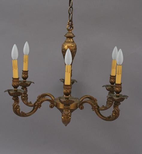 5078. Six Brass Light Chandelier with four candle-shaped bulbs against a gray background.