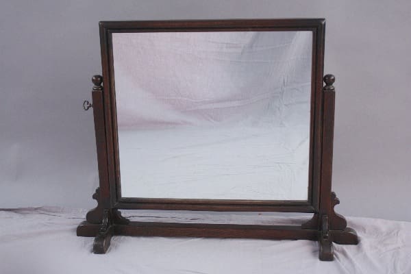 8641. Handsome Turn Of The Century Mirror On Stand with a square frame and stand, set against a draped white cloth backdrop.