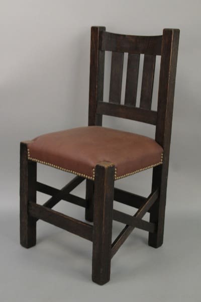 A 10208. Arts & Crafts Chair Newly Upholstered in Leather with brass stud detailing, standing against a neutral background.