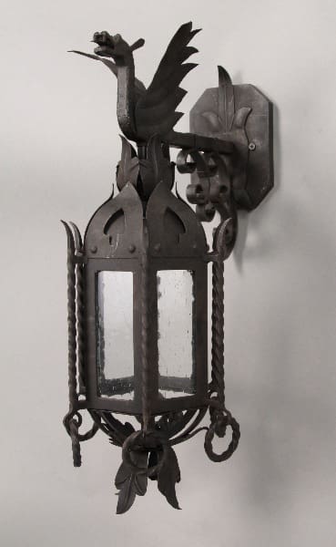 Ornate wrought iron wall lantern with dragon.