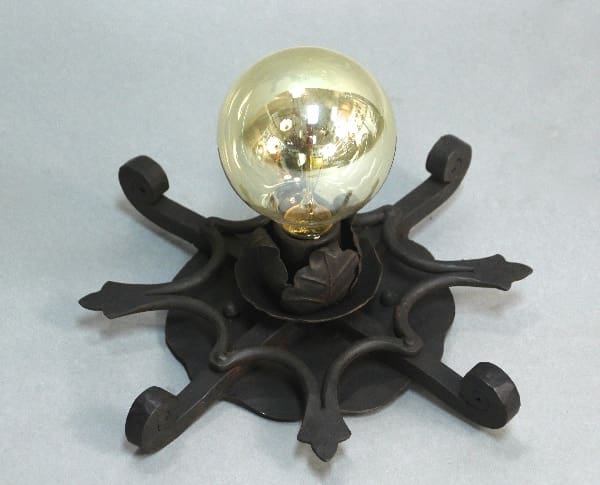 Black wrought iron ceiling light fixture.