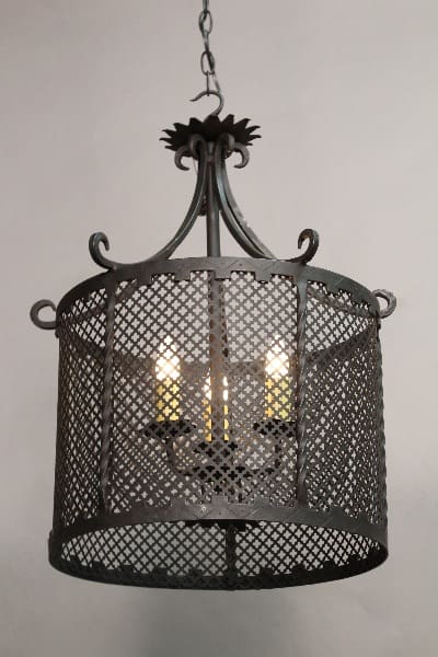 Black metal cage chandelier with lights.