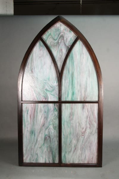 A 11322. 1 Of 4 Turn Of The Century Peaked Stained Glass Window with multicolored stained glass panels, standing against a plain backdrop.