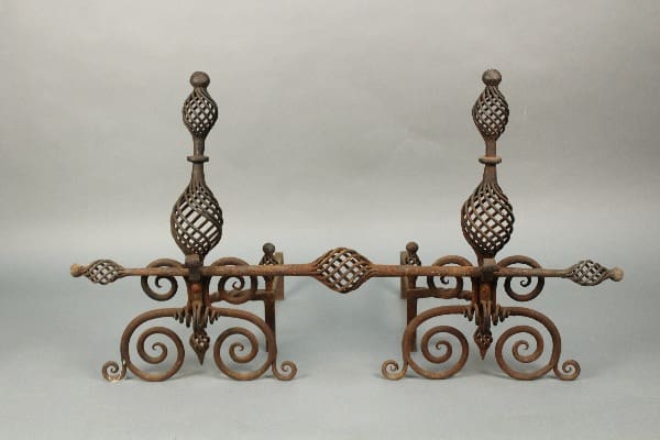 11464. Pair Of 1920's Andirons With Great Wrought Iron Work with intricate scroll designs and spherical elements on a plain background.