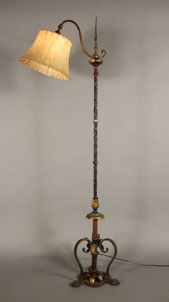 Ornate floor lamp with a shade.