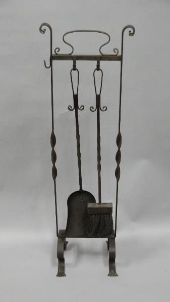 An antique 12083. 1920's Wrought Iron Fire Tool Set with a shovel and brush, set against a plain gray background.