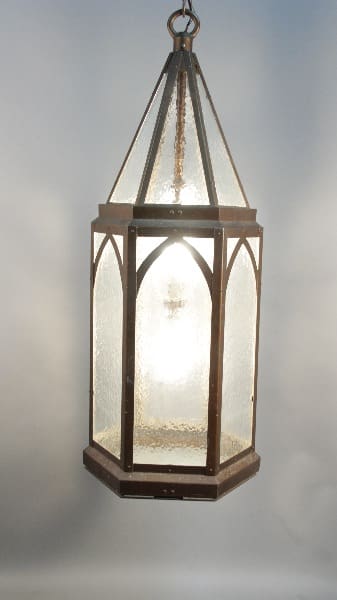 An antique lantern with a metal frame and frosted glass panels, illuminated from within, suspended against a soft, glowing background.
Product Name: 12185. HOLD ~ 1 Of 2 Large Scale Iron Tudor Pendant