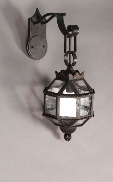 Ornate wrought iron wall-mounted lantern.