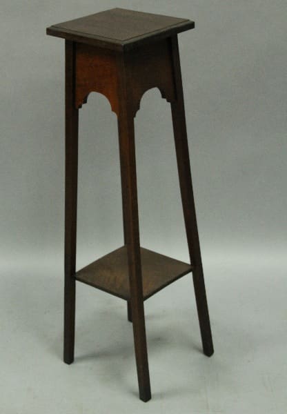 12422. Tall Arts And Crafts Stand With Shelf with arched detailing and a triangular lower shelf, against a grey backdrop.