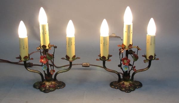Two 12678. Pair of Whimsical 1920's table lamps with polychrome finish with floral designs on metal branches, featuring five lit bulbs each, on a plain background.