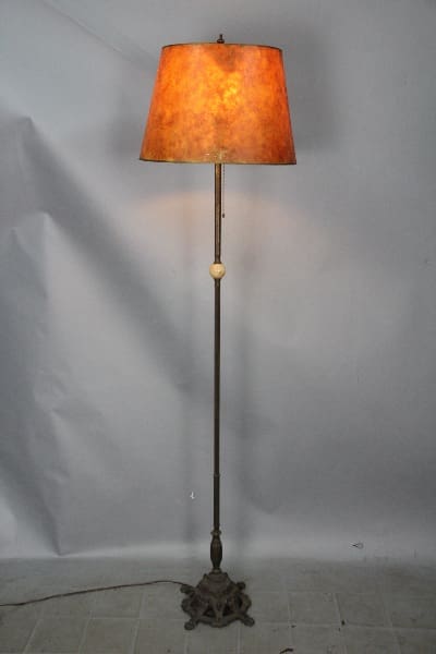 Antique floor lamp with a brown shade.