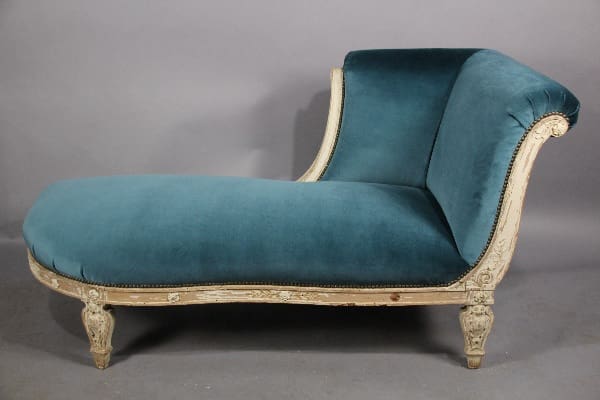 Elegant teal chaise lounge with ornate detailing.