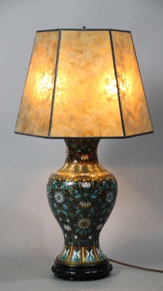 13046. Turn Of The Century Cloisonne Table Lamp With New Mica Shade with a colorful ceramic base featuring floral designs and a hexagonal beige shade.