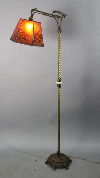 Antique floor lamp with brown shade.