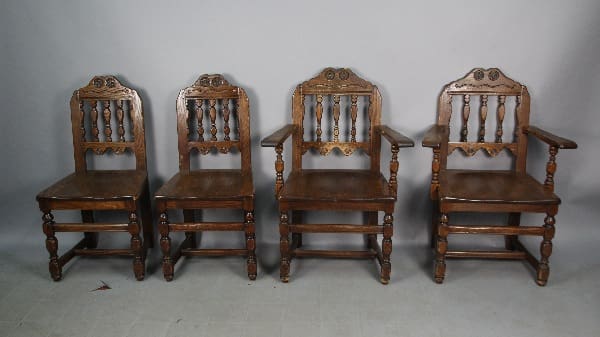 Four vintage wooden chairs in a row.