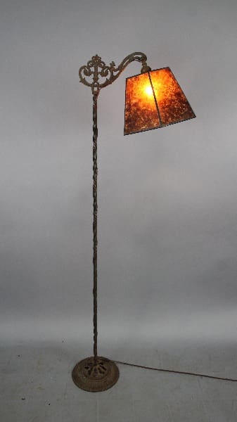 Antique floor lamp with ornate shade.