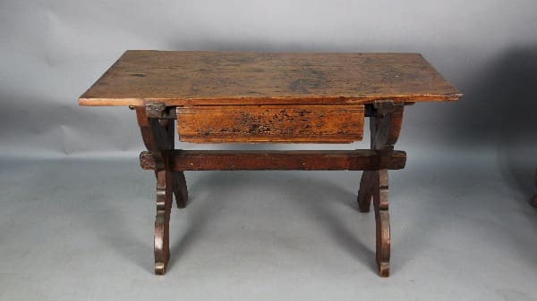 Antique 13126. Rustic European Farm Table 18th Century with a hinged top and visible wear, set against a gray backdrop.