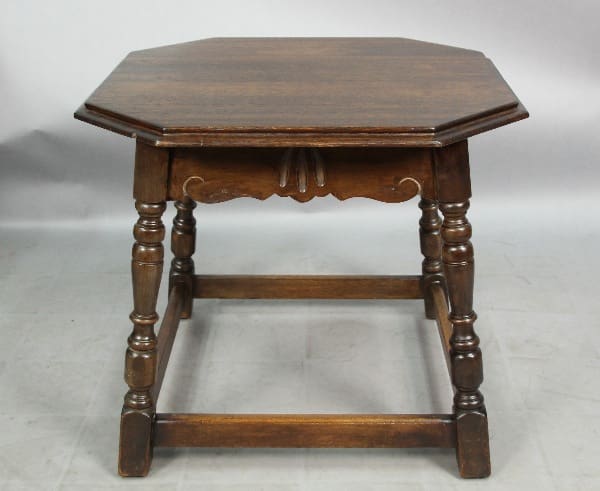 13173. 1920's Walnut Octagonal hexagonal wooden table with ornate legs and a lower shelf, set against a plain backdrop.