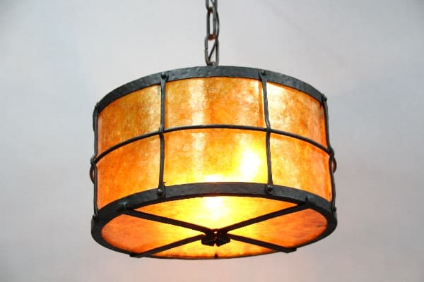 Hanging lamp with amber glass shade.