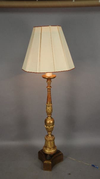 Gold table lamp with a white shade.