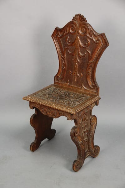 Ornate wooden chair with intricate carvings.