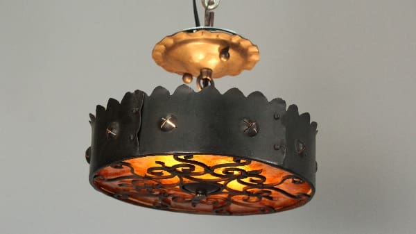 Ornate metal pendant light fixture hanging.