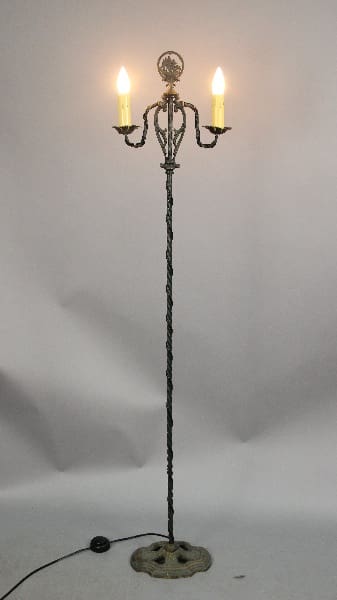 Vintage three-light floor lamp with candles.
