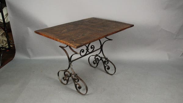 A vintage 13559. Spanish Revival Breakfast Table with Iron Base set against a neutral backdrop.