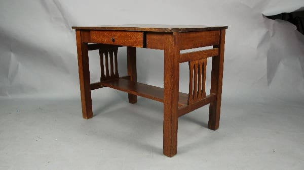 A 13591. Arts And Crafts Oak Desk with One Drawer, featuring vertical slat sides, displayed against a white backdrop.