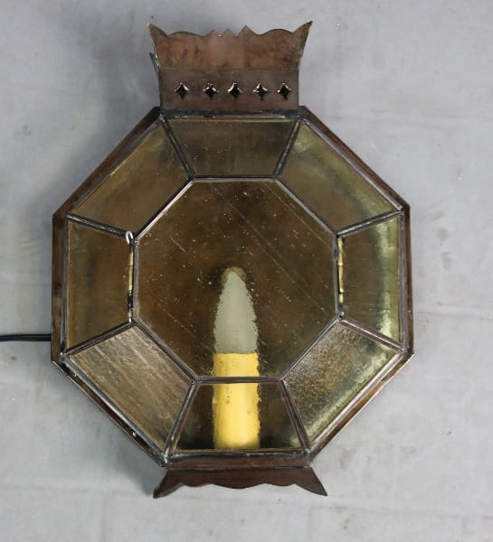 Octagonal vintage lamp with yellow candle.