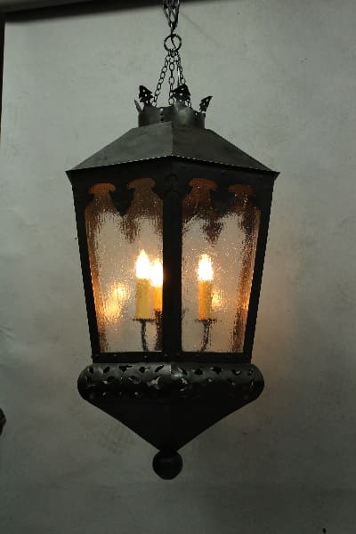 Hanging vintage lantern with glowing candles.