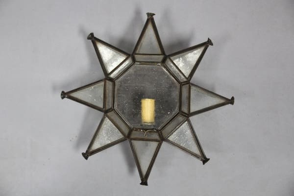 Star-shaped candle holder with glass panels.