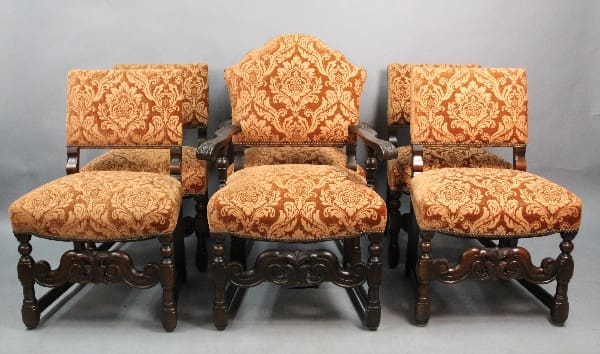 Ornate patterned chairs arranged in a row.