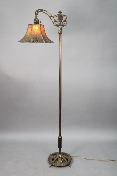 Antique 14115. 1920's Bridge Lamp with Galeon Motif base and metal shade, featuring a single bell-shaped shade, illuminated, against a plain backdrop.