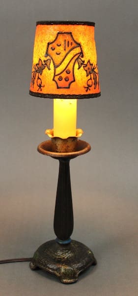 Spanish Revival Small Boudoir Lamp with a rustic base and a stained glass shade featuring autumn leaves, illuminated from within.