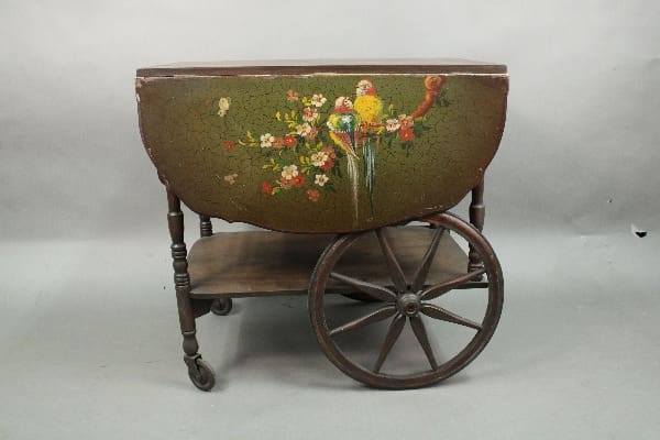 Vintage painted jardiniere on a 14496. 1920's Hand Painted Bar Cart With Bird Motif, featuring a colorful floral design with a bird on the front.