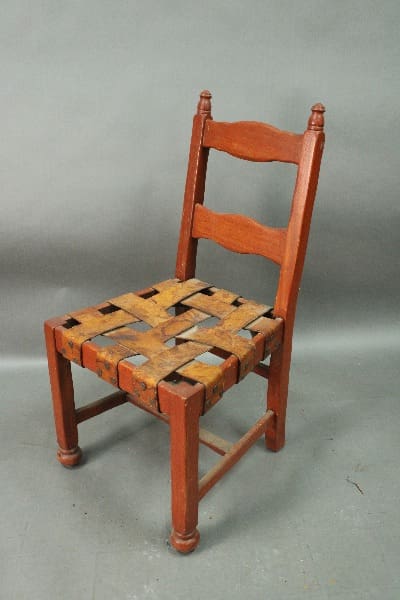 Vintage wooden chair with woven seat.
