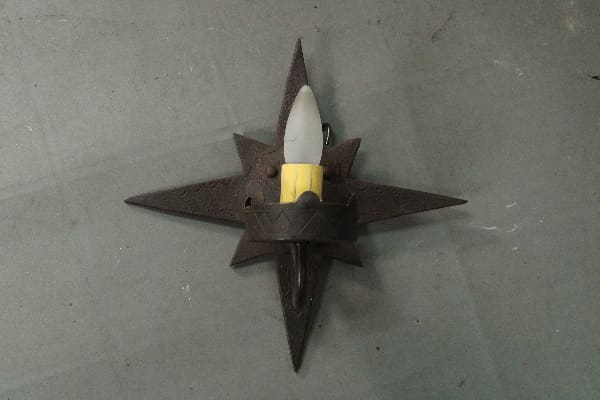 Star-shaped candle holder with white candle.