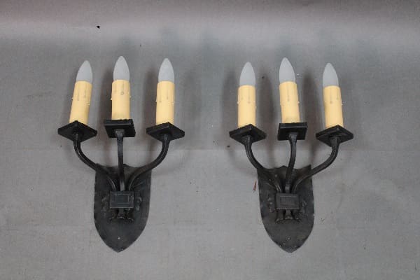 Two vintage candle wall sconces with lights.