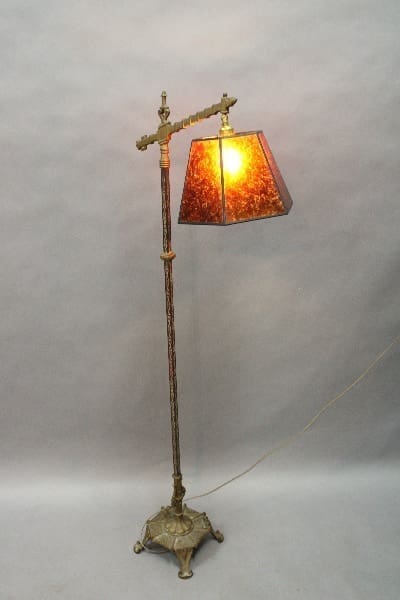 14854. Spanish Revival Floor Bridge Lamp With New Mica Shade with an ornate base and a stained glass lampshade, illuminated and standing against a plain background.