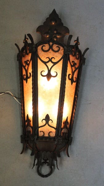 Ornate wall sconce with warm light.